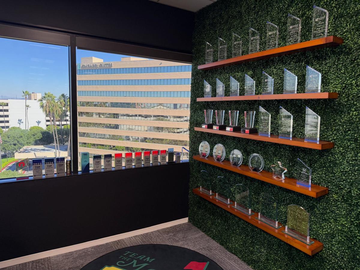 Shawn Way's awards from West Capital Lending, Rocket Pro and loanDepot on the wall and windowsill of his Irvine office